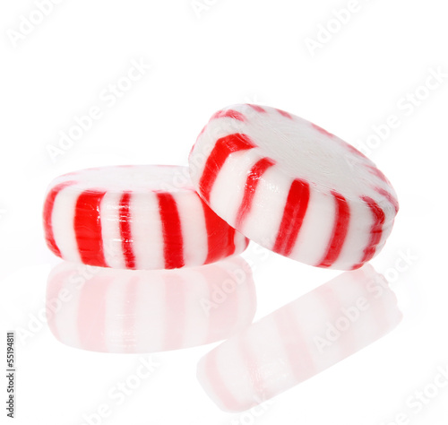 Photo: Peppermint candy. Red striped peppermint Christmas candy, macro. Peppermint candy. Red striped peppermint Christmas candy, macro.