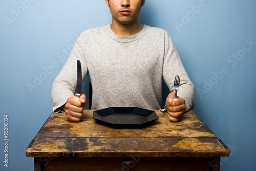 Photo: Young man waiting for his dinner Young man waiting for his dinner