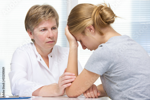 Photo: teenage girl in a conversation with a therapist teenage girl in a conversation with a therapist