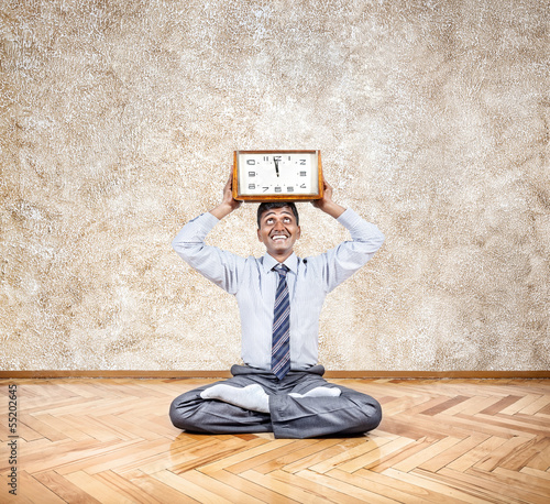 Photo: Business yoga with clock Business yoga with clock