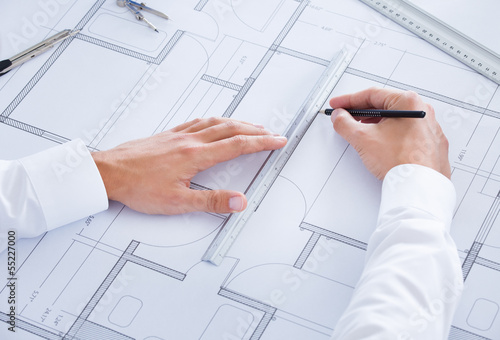 Photo: Architect Working On Blueprint Architect Working On Blueprint