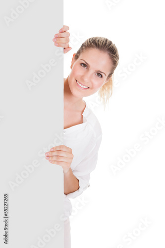 Photo: Young woman presenting blank placard Young woman presenting blank placard