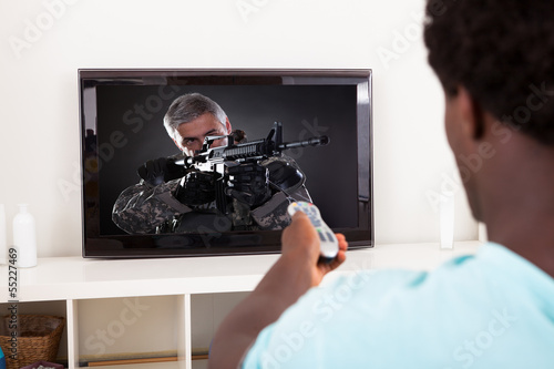 Photo: African Young Man Watching Television African Young Man Watching Television