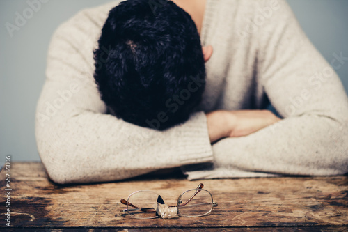 Photo: Sad man with broken glasses is in despair Sad man with broken glasses is in despair
