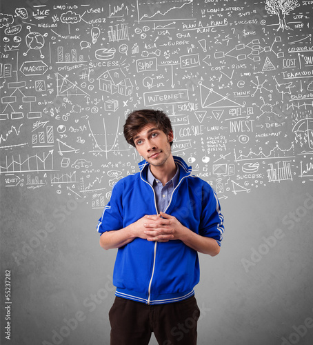 Photo: Young handsome guy with hand drawn calculations and icons Young handsome guy with hand drawn calculations and icons
