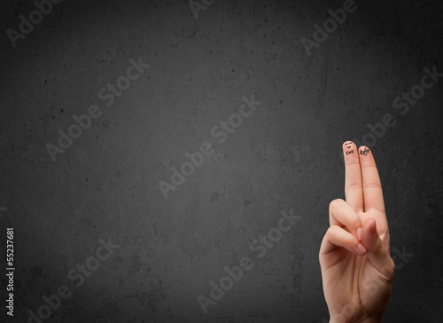 Photo: Happy finger smileys with empty copy space dark background Happy finger smileys with empty copy space dark background