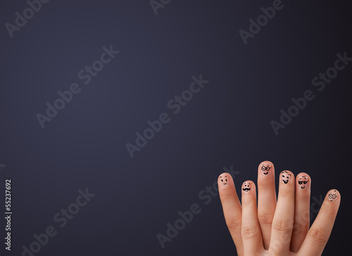 Photo: Happy smiley fingers looking at empty wall copyspace Happy smiley fingers looking at empty wall copyspace