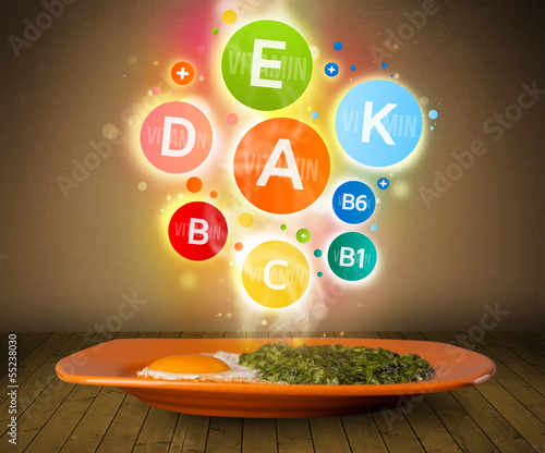 Photo: Food plate with delicious meal and healthy vitamin symbols Food plate with delicious meal and healthy vitamin symbols