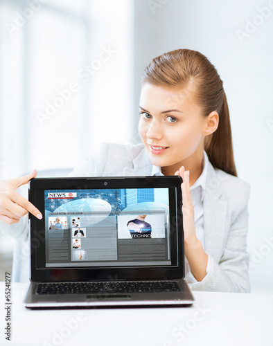 Photo: woman showing laptop pc with news woman showing laptop pc with news