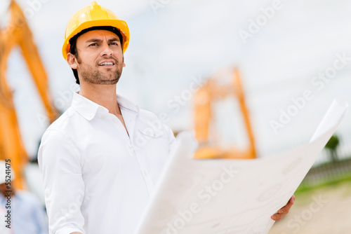 Photo: Engineer looking at blueprints Engineer looking at blueprints