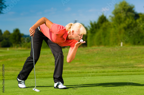 Photo: Young female golf player on course Young female golf player on course