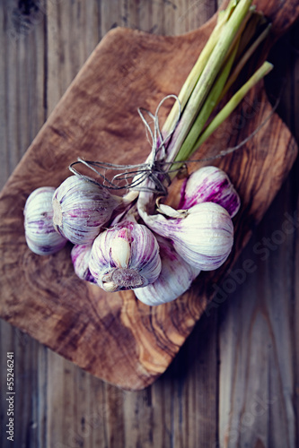 Photo: Garlic bulbs on a wooden kitchen board Garlic bulbs on a wooden kitchen board