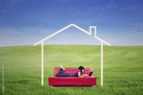 Photo: Asian female lying on sofa in dream house outdoor Asian female lying on sofa in dream house outdoor