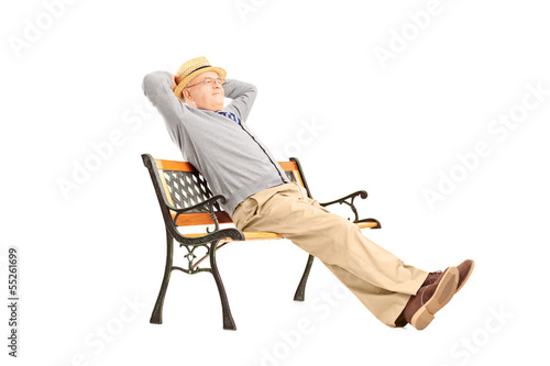 Photo: Mature man sitting on a wooden bench Mature man sitting on a wooden bench