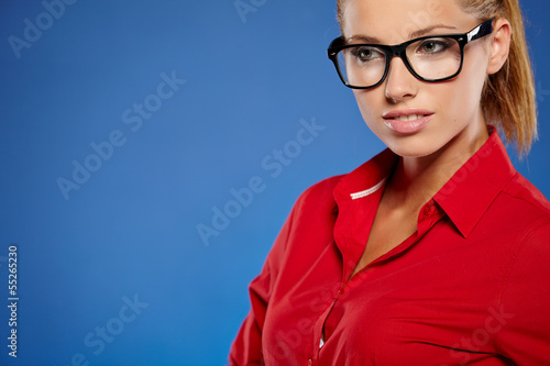 Photo: Young businesswoman on blue background Young businesswoman on blue background