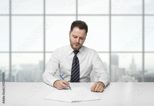 Photo: man writing on paper man writing on paper