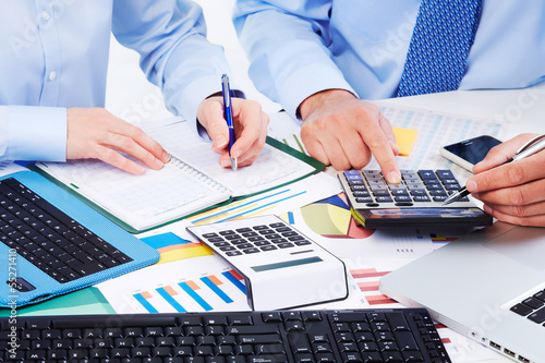 Photo: Hands of business people with calculator. Hands of business people with calculator.