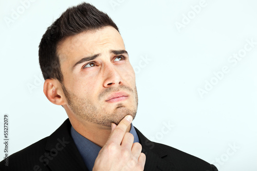 Photo: Thoughtful businessman with a hand on his chin Thoughtful businessman with a hand on his chin
