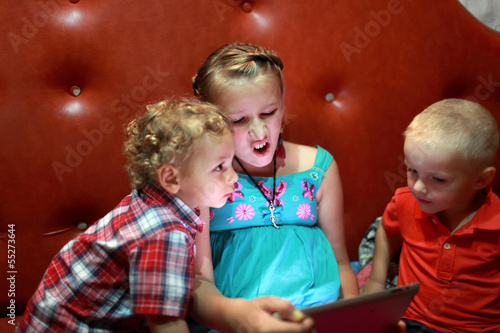 Photo: Children play with tablet PC Children play with tablet PC