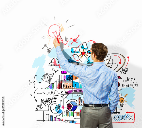 Photo: Businessman drawing sketches on wall Businessman drawing sketches on wall