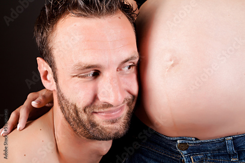 Photo: Young attractive couple. pregnant mother and happy father Young attractive couple. pregnant mother and happy father