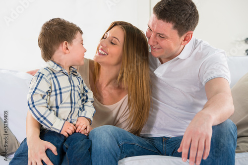 Photo: Beautiful happy family having fun at home Beautiful happy family having fun at home
