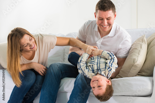 Photo: Beautiful happy family having fun at home Beautiful happy family having fun at home