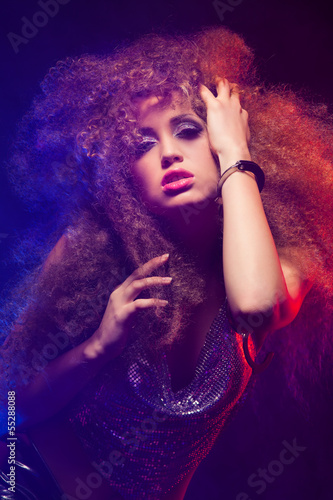 Photo: Woman with afro haircut is dancing disco Woman with afro haircut is dancing disco
