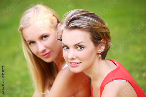 Photo: Two girls are having fun in the park Two girls are having fun in the park