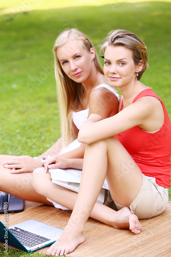 Photo: Two girls are having fun in the park Two girls are having fun in the park