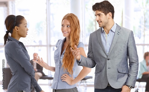 Photo: Businesspeople talking at office lobby Businesspeople talking at office lobby