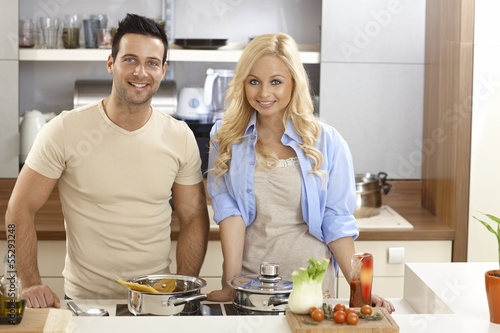 Photo: Attractive couple cooking at home Attractive couple cooking at home
