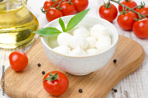 Photo: fresh mozzarella in a bowl, cherry tomatoes and olive oil fresh mozzarella in a bowl, cherry tomatoes and olive oil