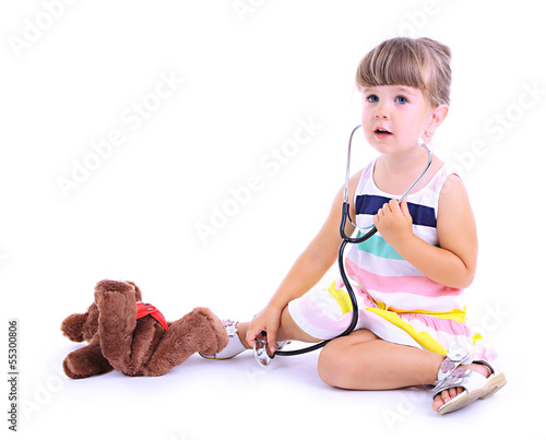 Photo: Little cute girl playing doctor, isolated on white Little cute girl playing doctor, isolated on white