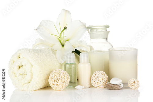 Photo: Beautiful spa setting with lily isolated on white Beautiful spa setting with lily isolated on white