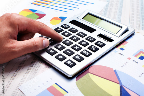 Photo: Hand with a calculator. Hand with a calculator.