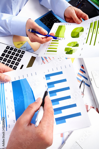 Photo: Hands of business people with calculator. Hands of business people with calculator.