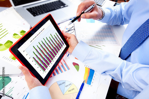 Photo: Business team working with tablet computer. Business team working with tablet computer.