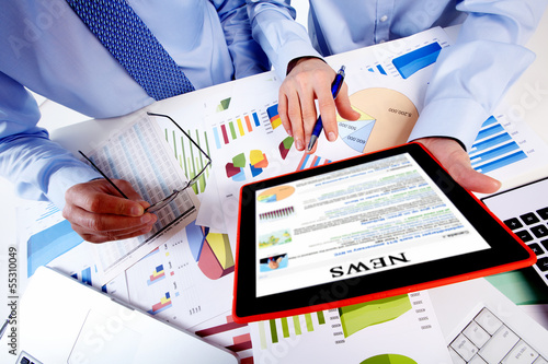 Photo: Business team working with tablet computer. Business team working with tablet computer.