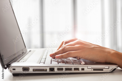 Photo: Woman using a laptop Woman using a laptop