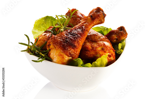 Photo: Grilled chicken legs and vegetables on white background Grilled chicken legs and vegetables on white background