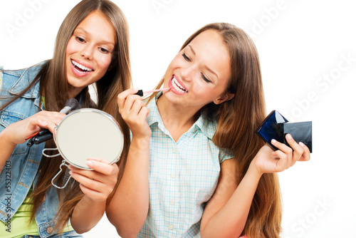 Photo: Pretty Teenage Girls Applying Make up and Looking in the Mirror Pretty Teenage Girls Applying Make up and Looking in the Mirror