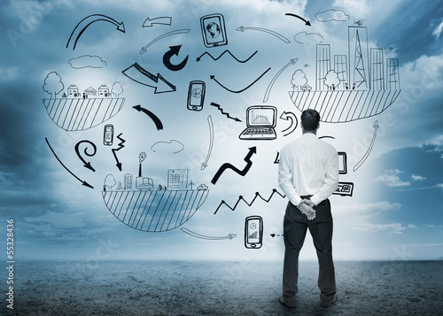 Photo: Businessman standing looking at business flowchart Businessman standing looking at business flowchart