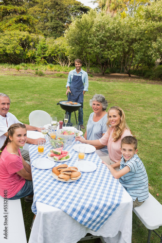 Photo: Cheerful extended family having a barbecue Cheerful extended family having a barbecue