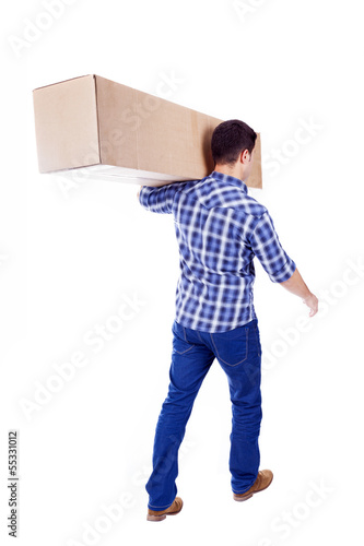 Photo: Man walking and carrying a cardbox isolated on white background Man walking and carrying a cardbox isolated on white background
