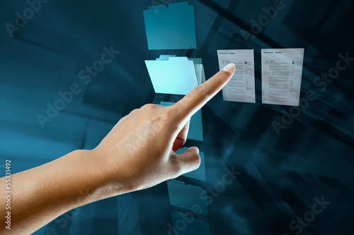Photo: a woman hand select and open a folder on a digital screen a woman hand select and open a folder on a digital screen
