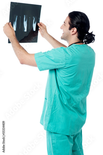 Photo: Doctor looking at scanned x-ray report Doctor looking at scanned x-ray report