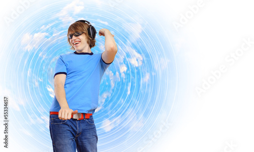 Photo: Happy smiling young man dancing Happy smiling young man dancing
