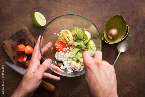 Photo: Mashing vegetables to make guacamole Mashing vegetables to make guacamole