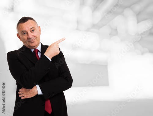 Photo: Businessman pointing his finger to the copy space Businessman pointing his finger to the copy space